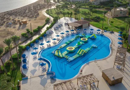 Aerial view of the pool complex and water slides with the bay behind