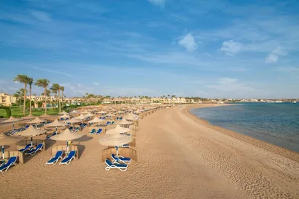 Loungers and parasols along the sandy curve of Makadi Bay