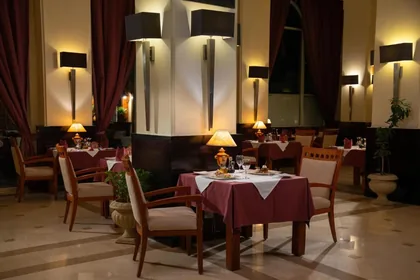 A la carte restaurant with linen-laid tables and warm lamplight