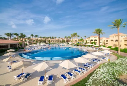 The main pool ringed by palms, sun loungers and blue parasols