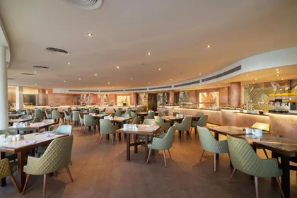 The main restaurant's dining room with curved windows