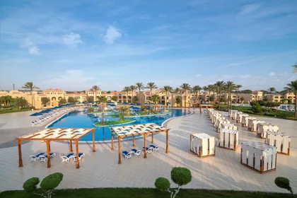 Poolside cabanas and loungers photographed from above at dusk