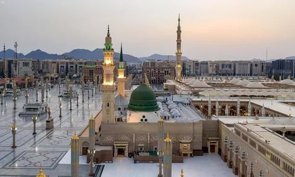 Al-Masjid an-Nabawi at dawn with the hills of Madinah behind