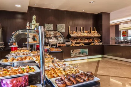 Breads and pastries arranged on the buffet display