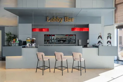 The lobby bar counter and stools under warm lighting