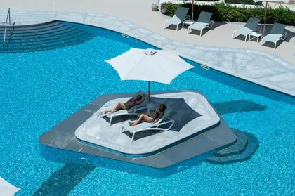 A shaded floating daybed set in the pool