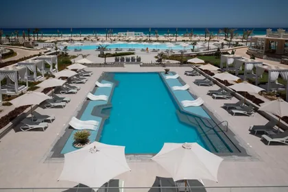 The pool, umbrellas and loungers seen from above at dusk