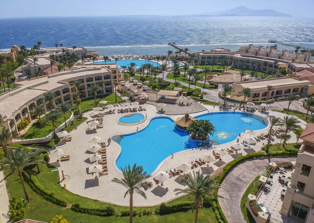 Aerial view of Cleopatra Luxury Resort Sharm El Sheikh with lagoon pools, palms and the Red Sea